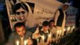 Pakistanis light candles in front of a banner showing a picture of 14-year-olschoolgirl Malala Yousufzai in Peshawar, Pakistan, Oct. 15, 2012. 