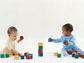 Photo of two babies playing with blocks.