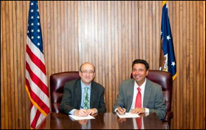 (L to R) Dr. David Michaels, Assistant Secretary, USDOL-OSHA, and Eric Rodriguez, Vice President - Research, Advocacy, and Legislation, National Council of La Raza, sign a national Alliance agreement on May 20, 2011.