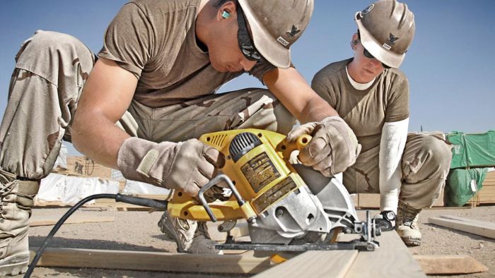 Two Construction Electricians cut bracing