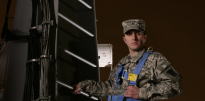 Portrait of a Radar Repair Specialist standing on a ladder