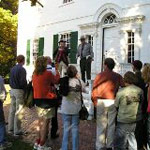 Visitors enjoy a presentation on the steps of the Ford Mansion