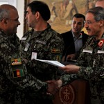 Afghan Col. Amanullah receives a certificate from Afghan Maj. Gen. Akramyar, deputy of Afghan MoD Strategy and Policy, certifying him as a MoD/ANA Programmer. Amanullah is one of 35 Afghan officers to graduate from a 44-week planning, programming, budgeting and execution class. The PPBE class taught the fundamentals of developing transparent and accountable three-year defense budget for Afghanistan. (U.S. Navy photo by Mass Communication Specialist 3rd Class Eric Lockwood)