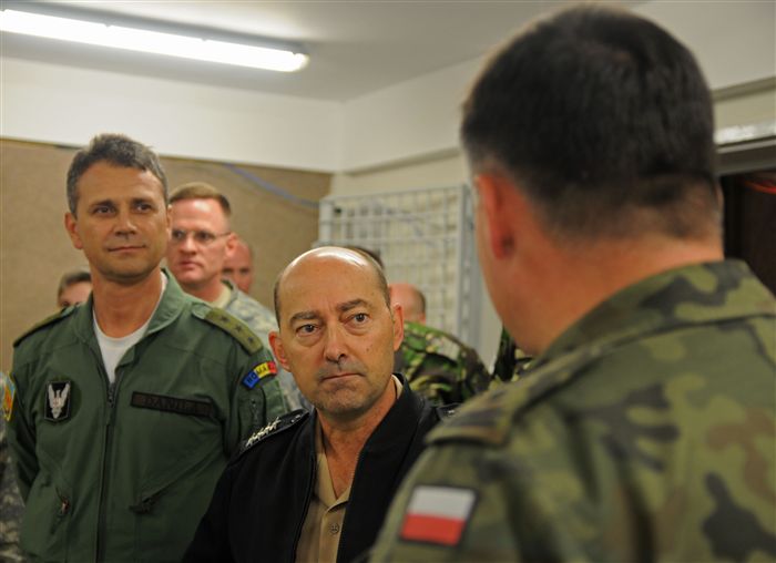 The Commander of the U.S. European Command, Adm. James G. Stavridis, center, and Romanian Maj. Gen. Ștefan Dănilă, Chief of the Romanian General Staff, left, listen to a Polish exercise participant taking part in the Jackal Stone 11 multinational special operations forces exercise on Mihail Kogălniceanu Air Base, Romania, Sept. 20, 2011. The purpose of the exercise, coordinated by Special Operations Command Europe, is to enhance special operations forces capacity and interoperability between the nine participating nations, while simultaneously building cooperation and partnerships. 