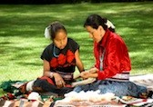 Mother teaching daughter to weave