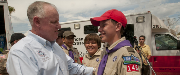 Man talking to boy scout