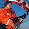 Armed man protecting American flag. 