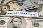 Social Security card mixed with dollar bills