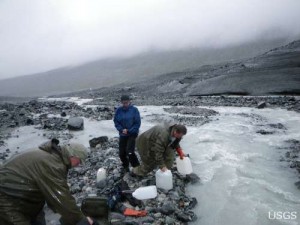 USGS scientists Doug Halm, Paul Schuster, and Kathy Kelsey collecting melt water samples from Gulkana Glacier.