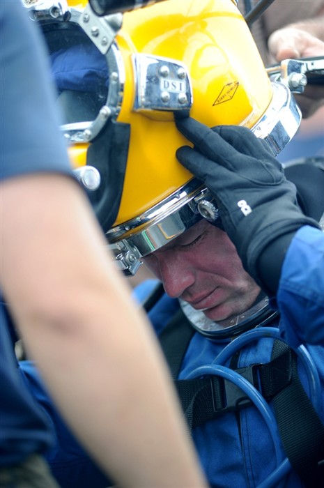 NORTH SEA (July 26, 2011) - Master Chief Navy Diver Kelly Polk, assigned to Mobile Diving and Salvage Unit (MDSU) 2, dons his KM-37 surface supply diving helmet aboard the Military Sealift Command rescue and salvage ship USNS Grasp (T-ARS 51). MDSU-2 and Navy archeologists, scientists, and historians are in the North Sea conducting diving operations verifying the sites of suspected shipwrecks. The researchers hope to find USS Bonhomme Richard, the historic ship commanded by John Paul Jones. (U.S. Navy Photo by Mass Communication Specialist 1st Class Ja&#39;lon A. Rhinehart/RELEASED)