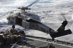 A MH-60S helicopter assigned to the Golden Falcons of Helicopter Sea Combat Squadron (HSC) 12 lands on the flight deck of the Nimitz-class aircraft carrier USS John C. Stennis (CVN 74).