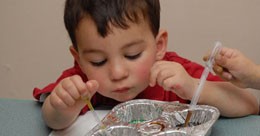 Preschool boy mixing paint colors