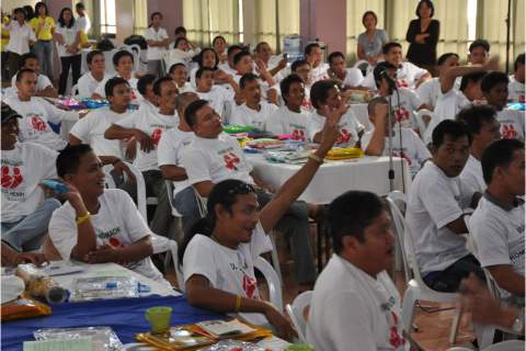 Male participants ask questions about male involvement in family health during an open forum. 