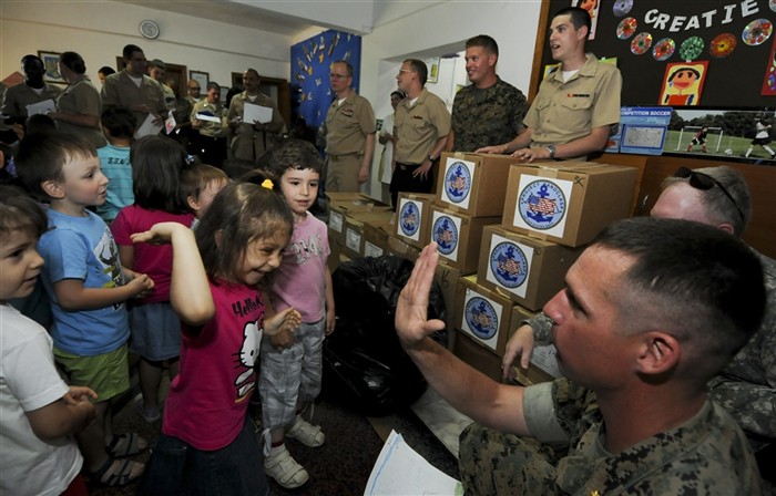CONSTANTA, Romania (June 8, 2011) - Maj. Todd Schunks a Marine attached to the Black Sea Rotational Force-11 (BSRF-11) high-fives a girl from the Constanta Kindergarden during a community relations project(COMREL). Sailors attached to the Ticonderoga-class guided-missile cruiser USS Monterey (CG 61) and Marines gave out Project Handclasp toys and school supplies. Monterey is homeported out of Norfolk and is supporting maritime security operations and theater security cooperation effort in the U.S. 6th Fleet area of responsibility. (U.S. Navy photo by Mass Communication Specialist 2nd Class Daniel Viramontes/Released)