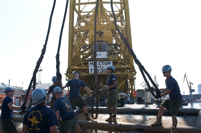 ODESSA, Ukraine - Sailors and Ukrainian service members work together to extract a submerged barge out of the water at the Ukrainian Western Naval Base during Exercise Sea Breeze 2012 (SB12) evaluation. SB12, co-hosted by the Ukrainian and U.S. navies, aims to improve maritime safety, security and stability engagements in the Black Sea by enhancing the capabilities of Partnership for Peace and Black Sea regional maritime security forces.