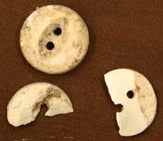 (photo) Bone buttons with a little dirt on them. (NPS)