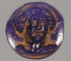 (photo) A blue token imprinted with a woman's head. (NPS)