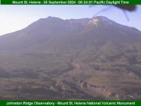 An image of Mount St. Helens with a fly on the lens.  Everyone just wants their picture taken with an active volcano!