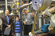 At the last Open House, laboratory director Eric Isaacs (left) and son Nathan visit the Gammasphere with Robert Janssens (right).