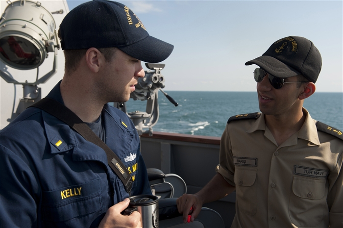 BLACK SEA - Ensign Ryan Kelly speaks with Turkish midshipman Fatih Baris aboard the guided-missile destroyer USS Jason Dunham (DDG 109) during the at-sea portion of Exercise Sea Breeze 2012 (SB12). SB12, co-hosted by the Ukrainian and U.S. navies, aims to improve maritime safety, security and stability engagements in the Black Sea by enhancing the capabilities of Partnership for Peace and Black Sea regional maritime security forces. 