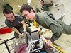 Boston University students Joshua Koerpel and Christopher Hoffman test a solar array deployment system for use on CubeSats as they float in very low gravity during a parabolic flight in Zero-G Corporation's modified Boeing 727 jetliner.