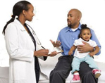 Man with a toddler talking to a pediatrician