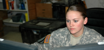 Soldier working at two computer screens