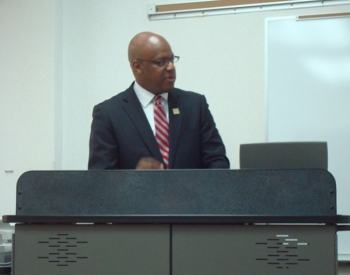 Wade speaking from lectern