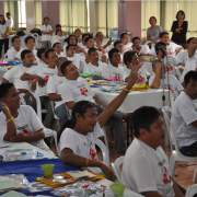 Male participants ask questions about male involvement in family health during an open forum. 