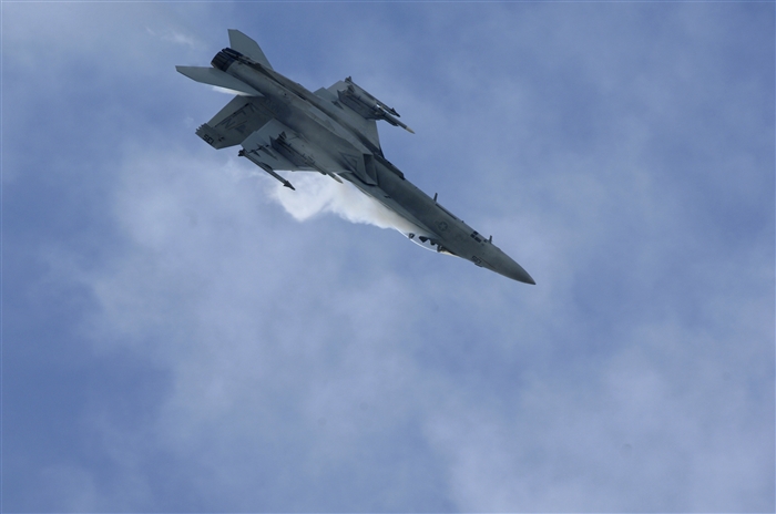 A U.S. Navy F/A-18F Super Hornet soars through the sky, July 10, 2012, during the Farnborough International Air Show in Farnborough, England. Approximately 90 aircrew and support personnel from bases in Europe and the United States are participating in the air show. Participation in this premier event demonstrates that U.S. defense industry offers state-of-the-art capabilities vital for the support and protection of our allies' and partners' national-security interests.