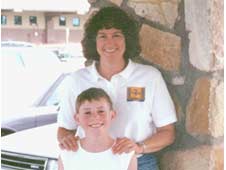 A young Michael Hallock III poses with Astronaut Laurel Clark when Clark was returning to Houston after speaking at the White Sands Test Facility Friends and Family Day in 2002. Clark, who attended middle school in New Mexico, also visited White Sands Space Harbor in 2001 for its 25th Anniversary