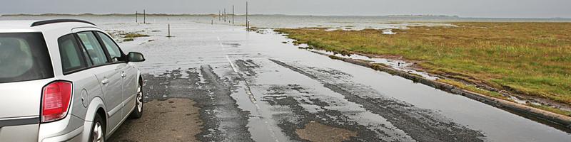 September 15th, 2003. A car is stopped as flooding waters rise on the road.