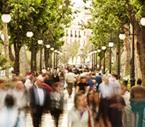 People walking on a tree-lined street.