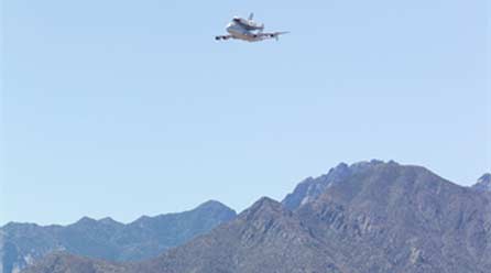 (NASA WSTF Photo) Space Shuttle Atlantis makes a low pass with the Organ Mountains in the background on June 1, 2009.