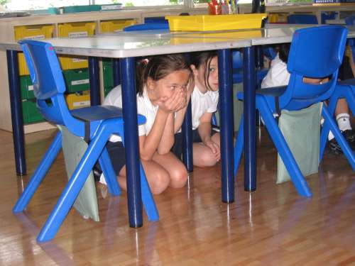 Children participating in an earthquake drill on April 23, 2009, at the British School in Tokyo, Showa Campus. The drill is based on the Japanese Earthquake Early Warning System.