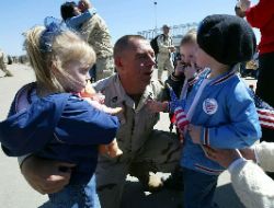 Date: 04/10/2004 Location: North Kingstown, R.I Description: Sgt. Tom Burdick of Warwick, R.I. is greeted by his four-year-old triplets upon his return home. © AP Image