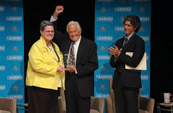 Dr. T. Berry Brazelton accepts the SAMHSA Special Recognition Award from SAMHSA Administrator Pamela S. Hyde, J.D., as Dr. Joshua Sparrow looks on.