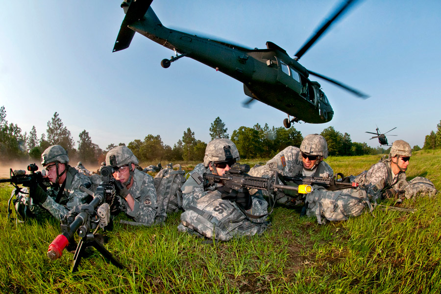 Paratroopers with the 82nd Airborne Division's 1st Brigade Combat Team pull security as their UH-60M Black Hawk helicopter leaves during air assault training