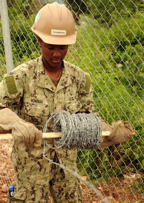 U.S. Navy Seaman Alexandria Bowman, Naval Mobile Construction Battalion 3 from Port Hueneme, Calif., unrolls barbed wire before installing it onto a 2.4 kilometer perimeter fence here May 29. The battalion constructed the fence around the Bosnian-Herzegovinian military compound to meet force protection requirements for the participants of Shared Resilience 2012, a two-week U.S. Joint Chiefs of Staff sponsored medical exercise. NMCB 3 is an expeditionary naval construction element currently assigned to U.S. Naval Forces Europe 6th Fleet's Task Force 68 to provide construction, engineering and security services that support national strategy, naval power projection, humanitarian assistance and contingency operations.
