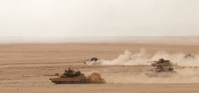 M1A2 Abrams Tanks of the 2nd Combined Arms Battalion, 8th Cavalry maneuver before engaging targets during a Combined-Arms Live-Fire Exercise with the Kuwaiti Army's 151st Tank Battalion, 15th Mubarak Armored Brigade, at northern Kuwait's Udari Range, May 8, 2012.  The 2nd Combined Arms Battalion belongs to the 1st Brigade Combat Team, 1st Cavalry Division (Iron Horse). The exercise also involved the brigade's 1st Battalion, 82nd Field Artillery, the brigade headquarters, and the 29th Combat Aviation Brigade.