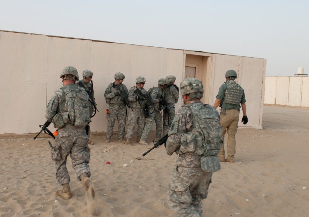 Soldiers of Company A, 4th Battalion, 118th Infantry Regiment form up to enter and clear a building as part of a platoon live-fire exercise at the Udairi Range Complex in northern Kuwait, July 31, 2012. The Soldiers also cleared a trench system during the exercise. In addition to undertaking camp and security-force operations, the South Carolina Army National Guard Soldiers have kept up the pace of their training since deploying to Kuwait in April.