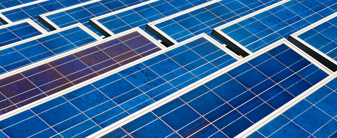 Photo of an array of bright blue solar panels.