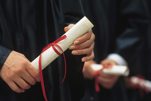 Photo of graduate holding diploma.