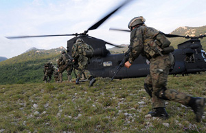 A Polish Special operations assault team dashes to the rear of an U.S. Army MH-47 helicopter during fast rope insertion/extraction system training during Exercise Jackal Stone 09 in Croatia. 