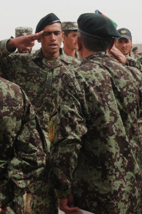 A newly graduated Afghan National Army soldier salutes a senior officer of the 205th Hero Corp after receiving a certificate of excellence during the Regional Military Training Center-Kandahar graduation ceremony at Camp Hero, Afghanistan, Sept. 13, 2012. The center graduated more than 1,000 soldiers at the ceremony from both the basic training course and the officer basic course.