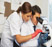Image of lab techs looking in microscope