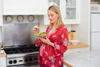 Photo of a pregnant woman eating a snack