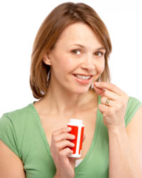 Photo: A woman taking folic acid.