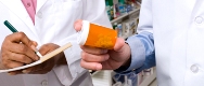 Photo of a pharmacist holding a prescription bottle