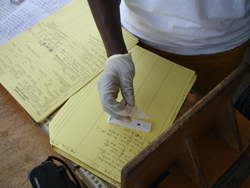 In Liberia, a worker uses an RDT to test a blood sample for malaria. Credit: Bob Wirtz, CDC